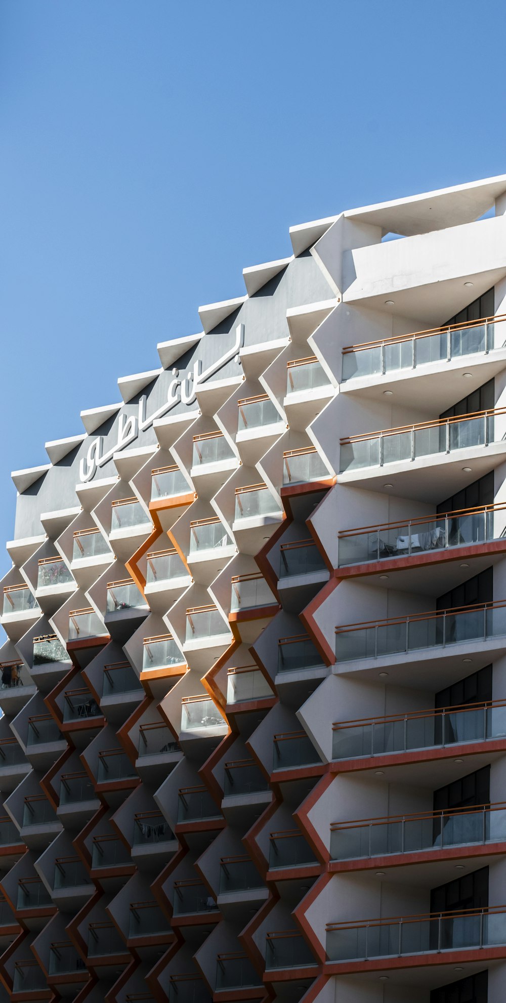 a tall building with many balconies on top of it