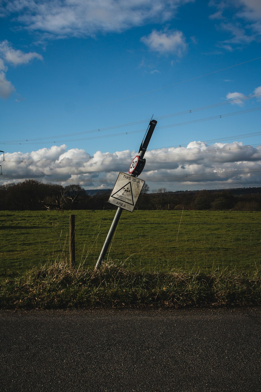 a street sign that has been knocked over in a field