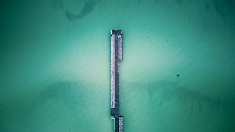 an aerial view of a pier in the ocean