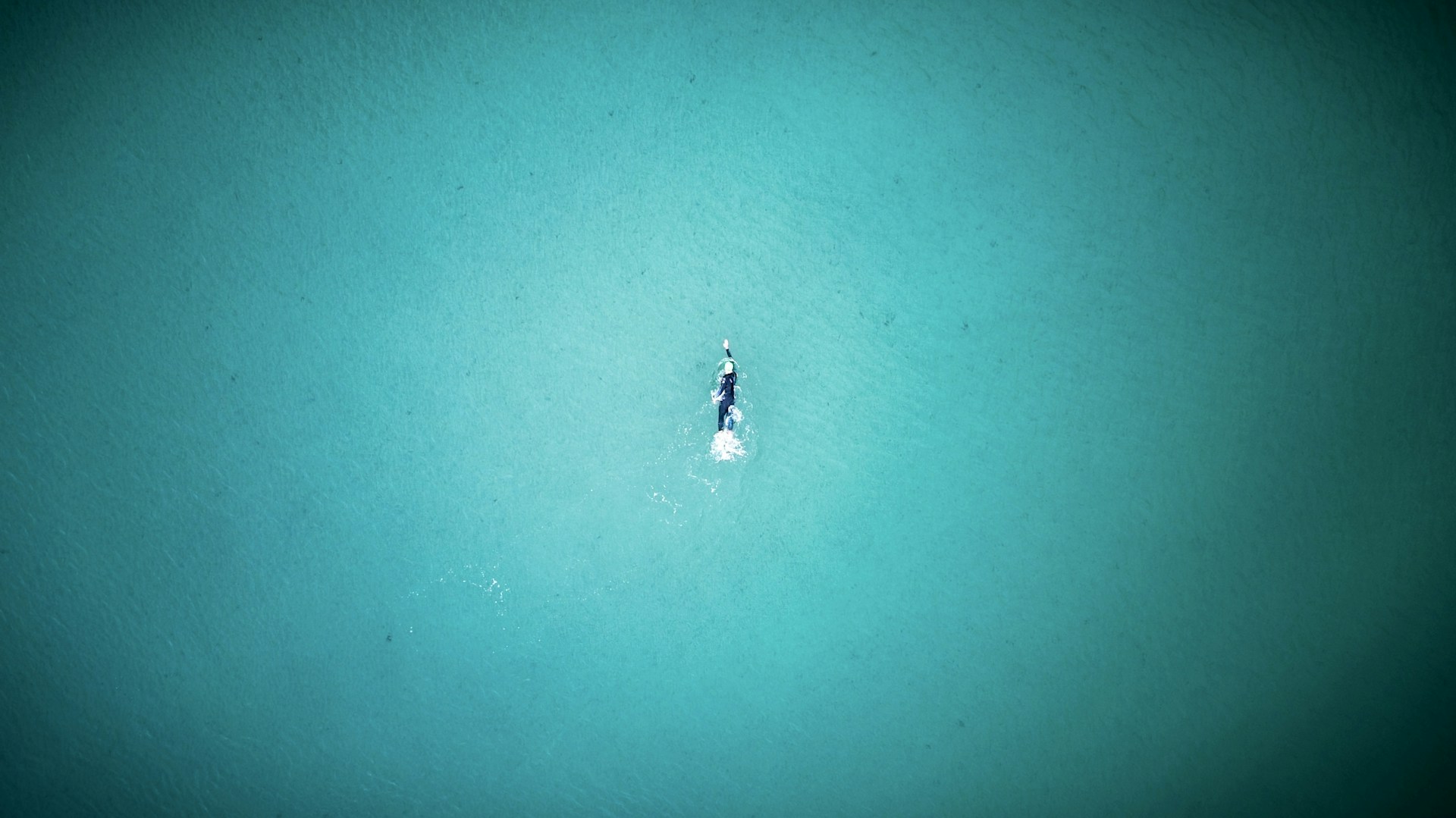 an aerial view of a boat in the water