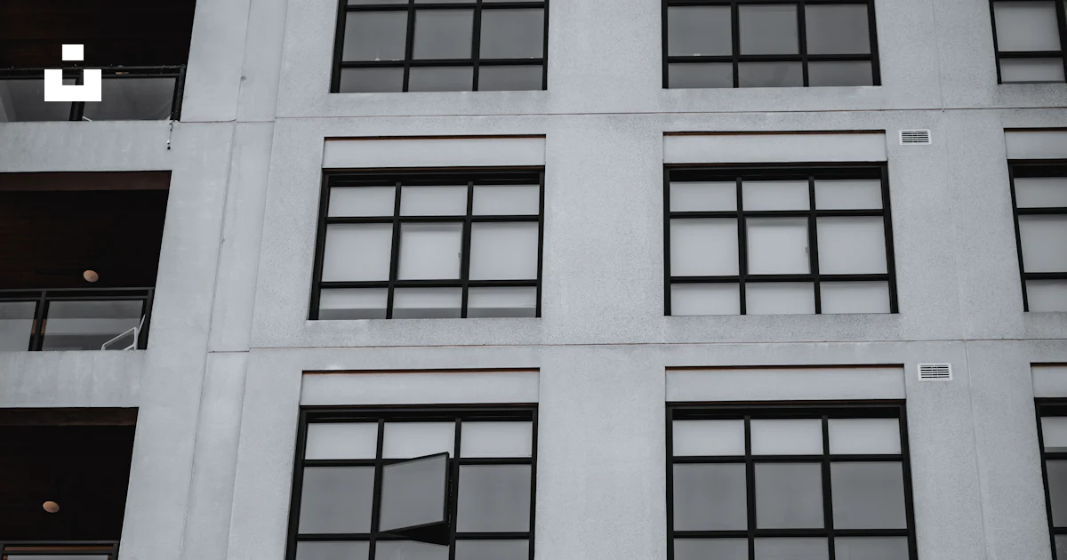 A tall white building with lots of windows photo – Free Windows Image ...