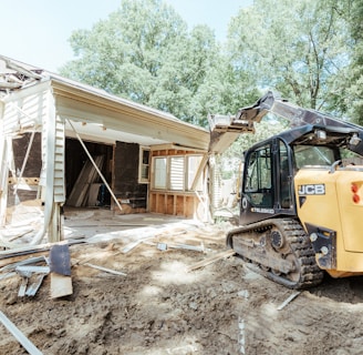 a bulldozer is parked in front of a house