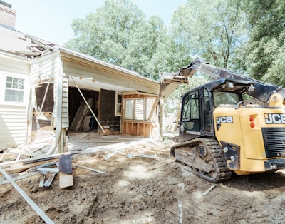 a bulldozer is parked in front of a house