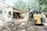a bulldozer is parked in front of a house