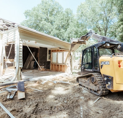 a bulldozer is parked in front of a house