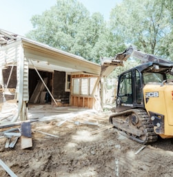 a bulldozer is parked in front of a house