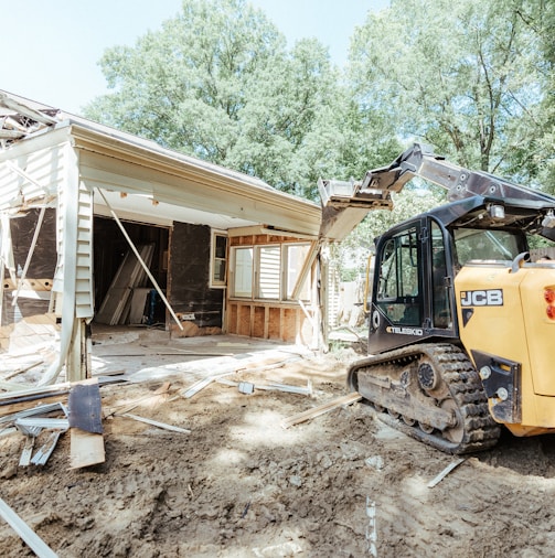 a bulldozer is parked in front of a house