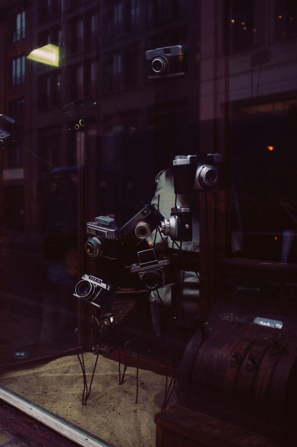 a window display with a camera and other items