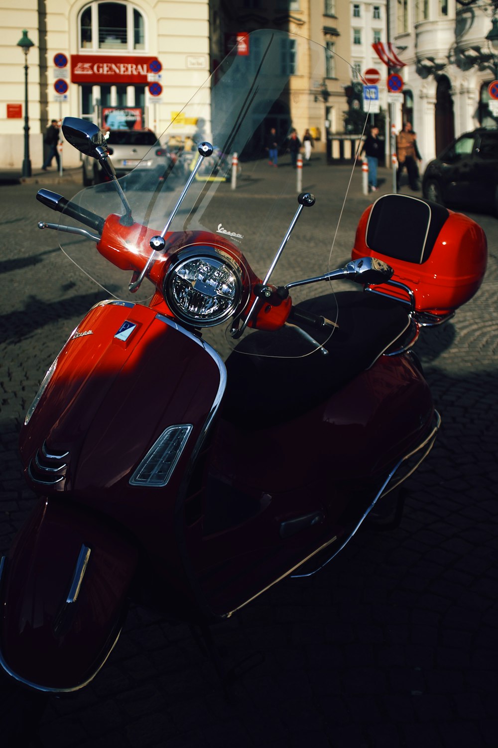 a red motorcycle parked on the side of a road