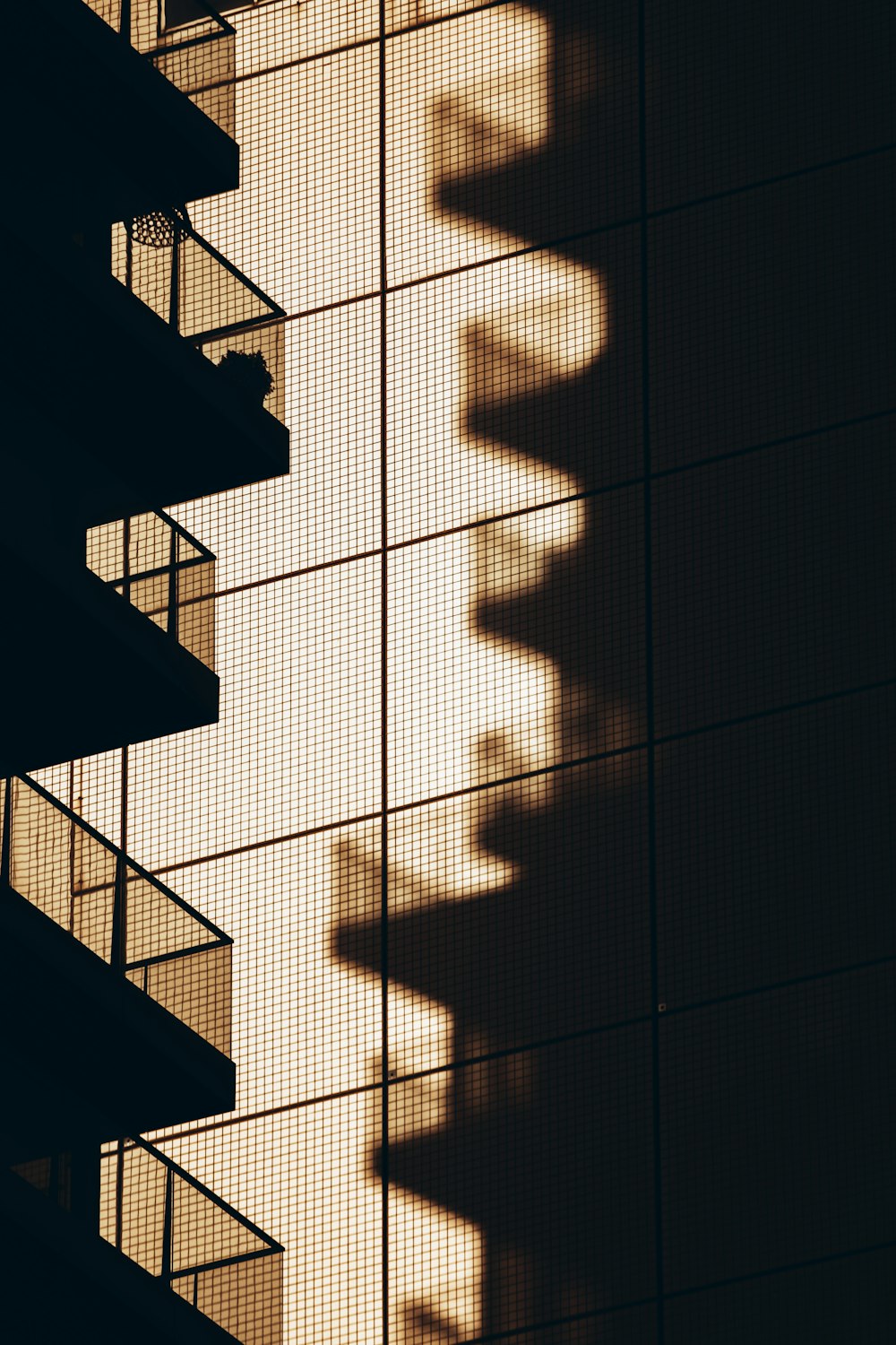 the shadow of a building on the side of it