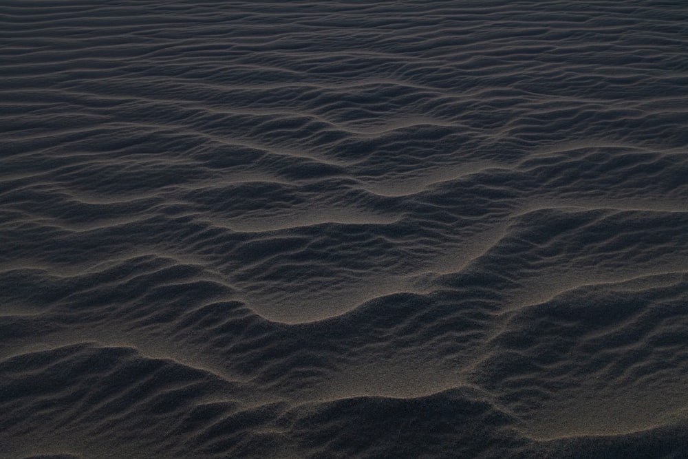 a sandy beach covered in lots of wavy sand