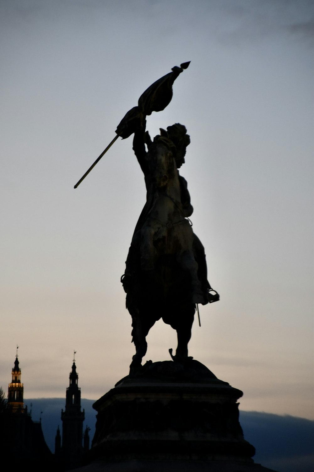 a statue of a man holding an umbrella on top of a building