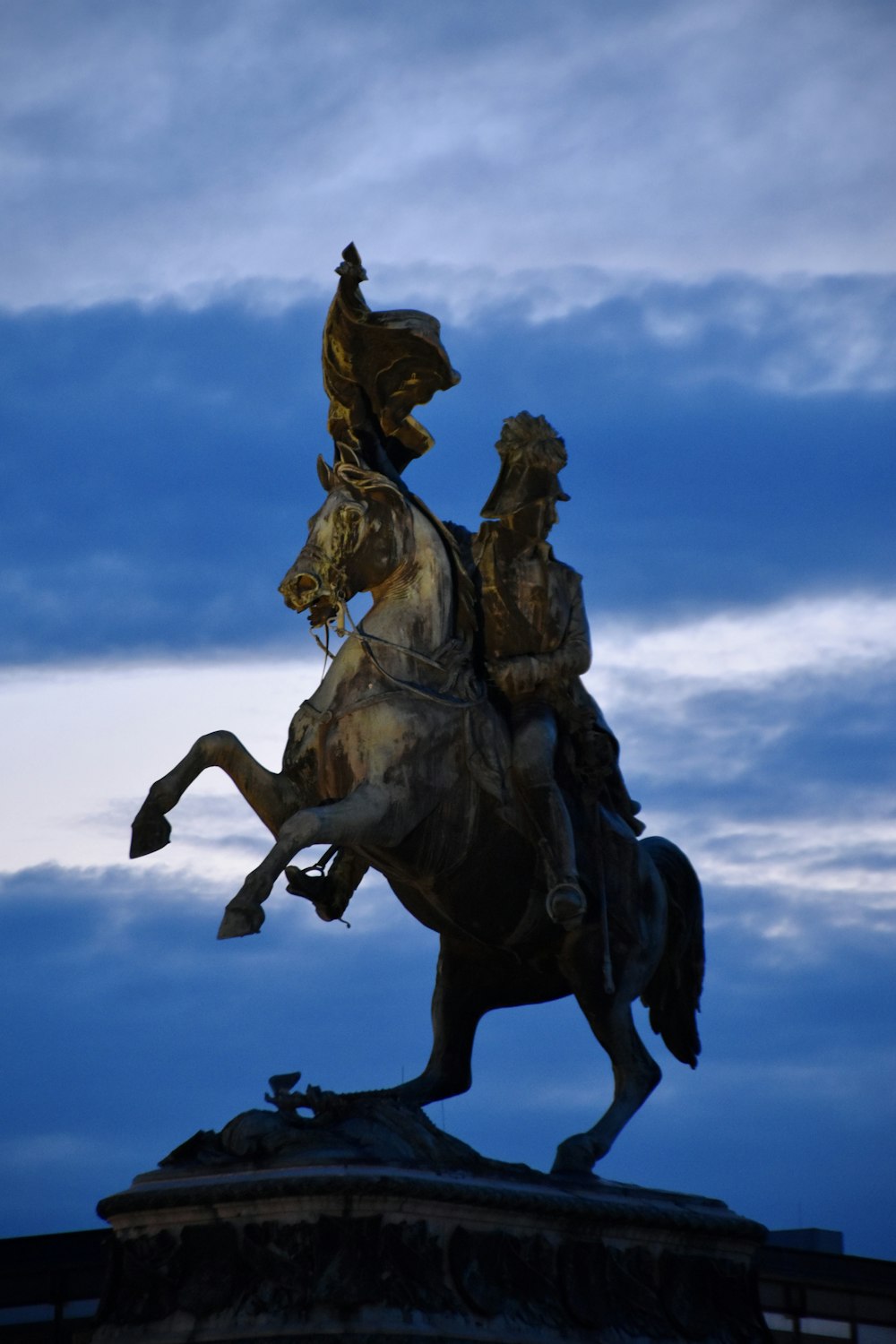 a statue of a man riding on the back of a horse