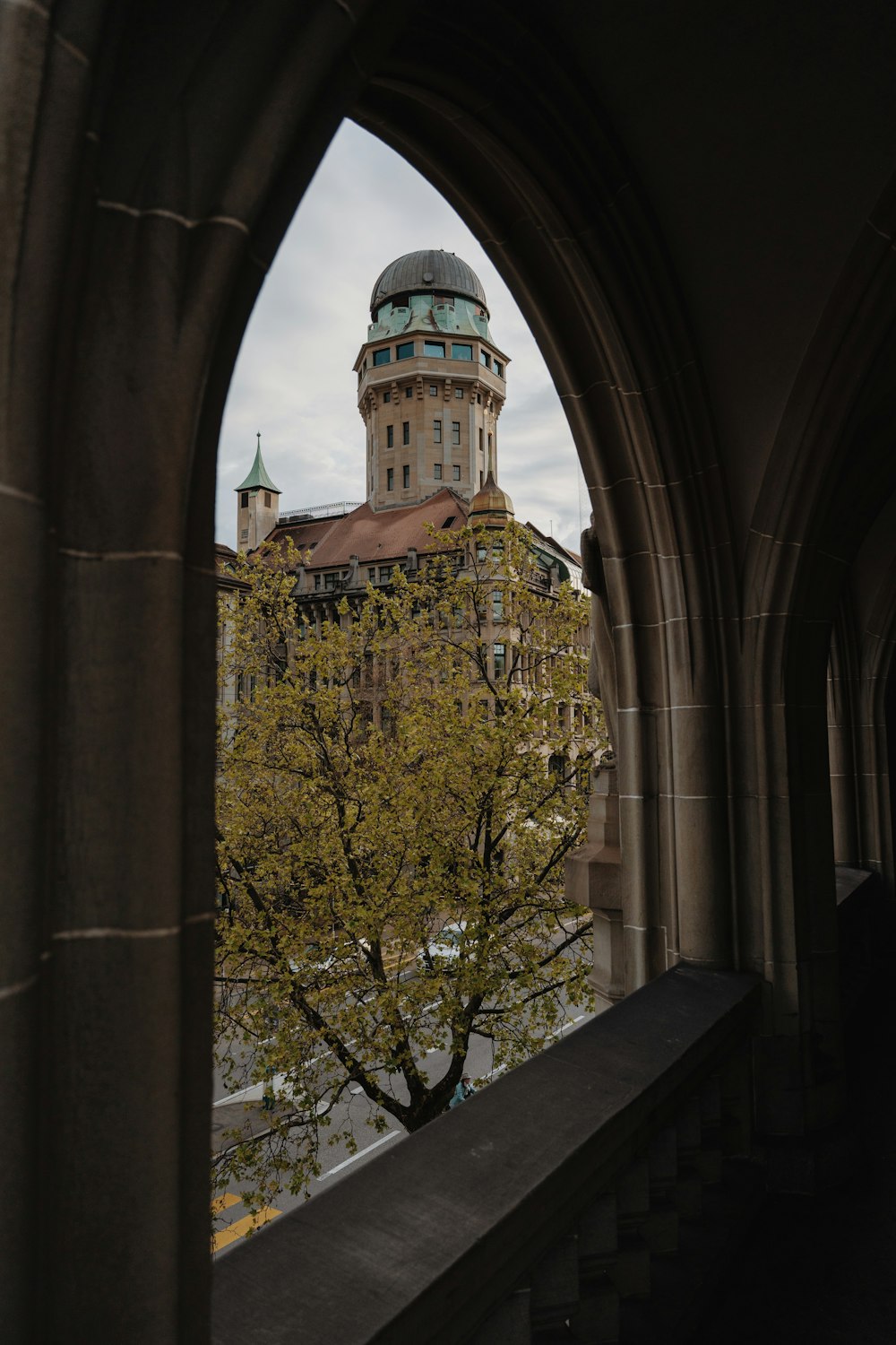 a view of a building through an arched window
