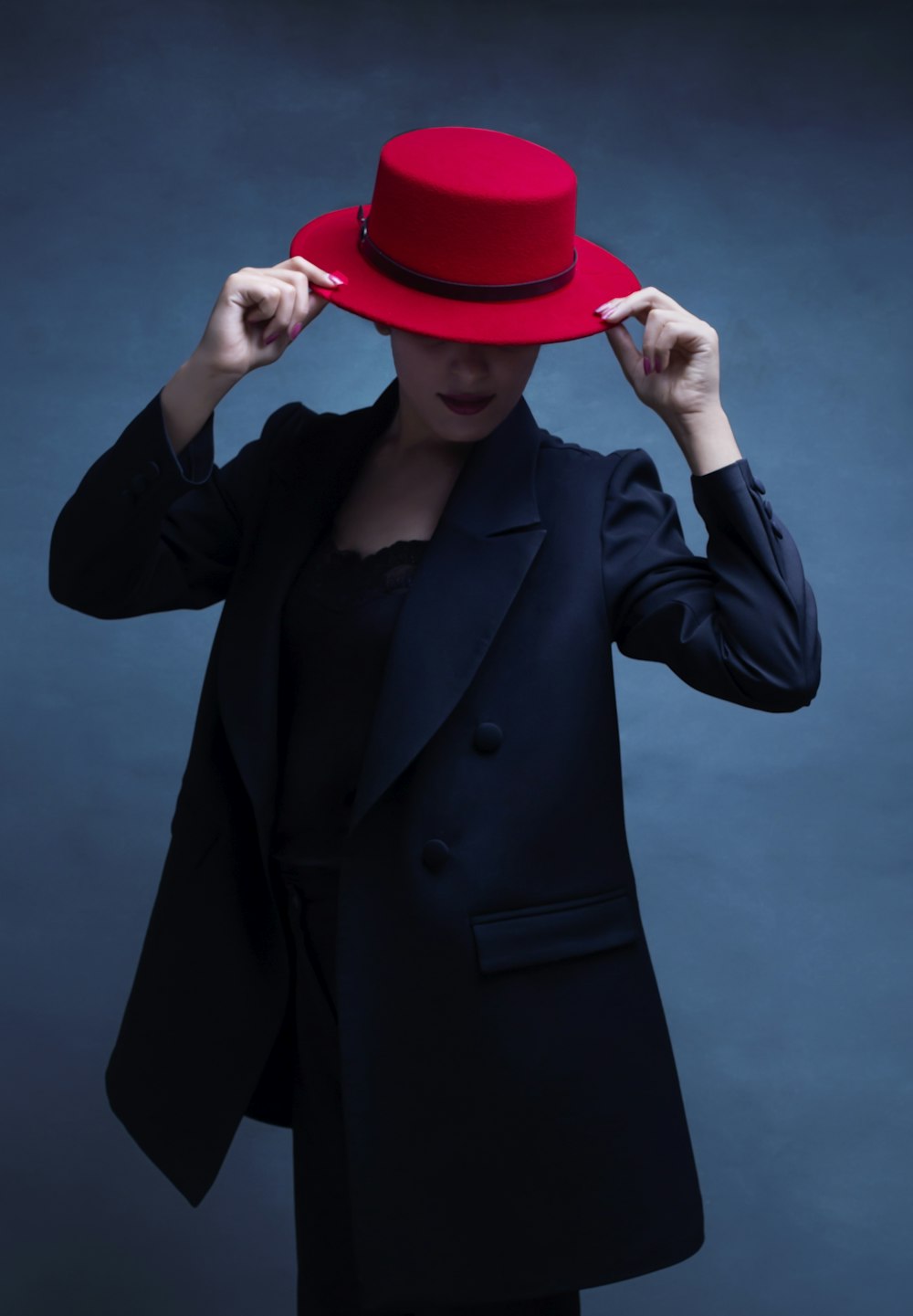 a woman wearing a red hat and a black jacket