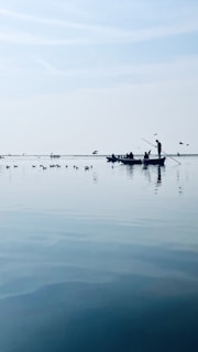 A family enjoying a boat ride on a serene lake.