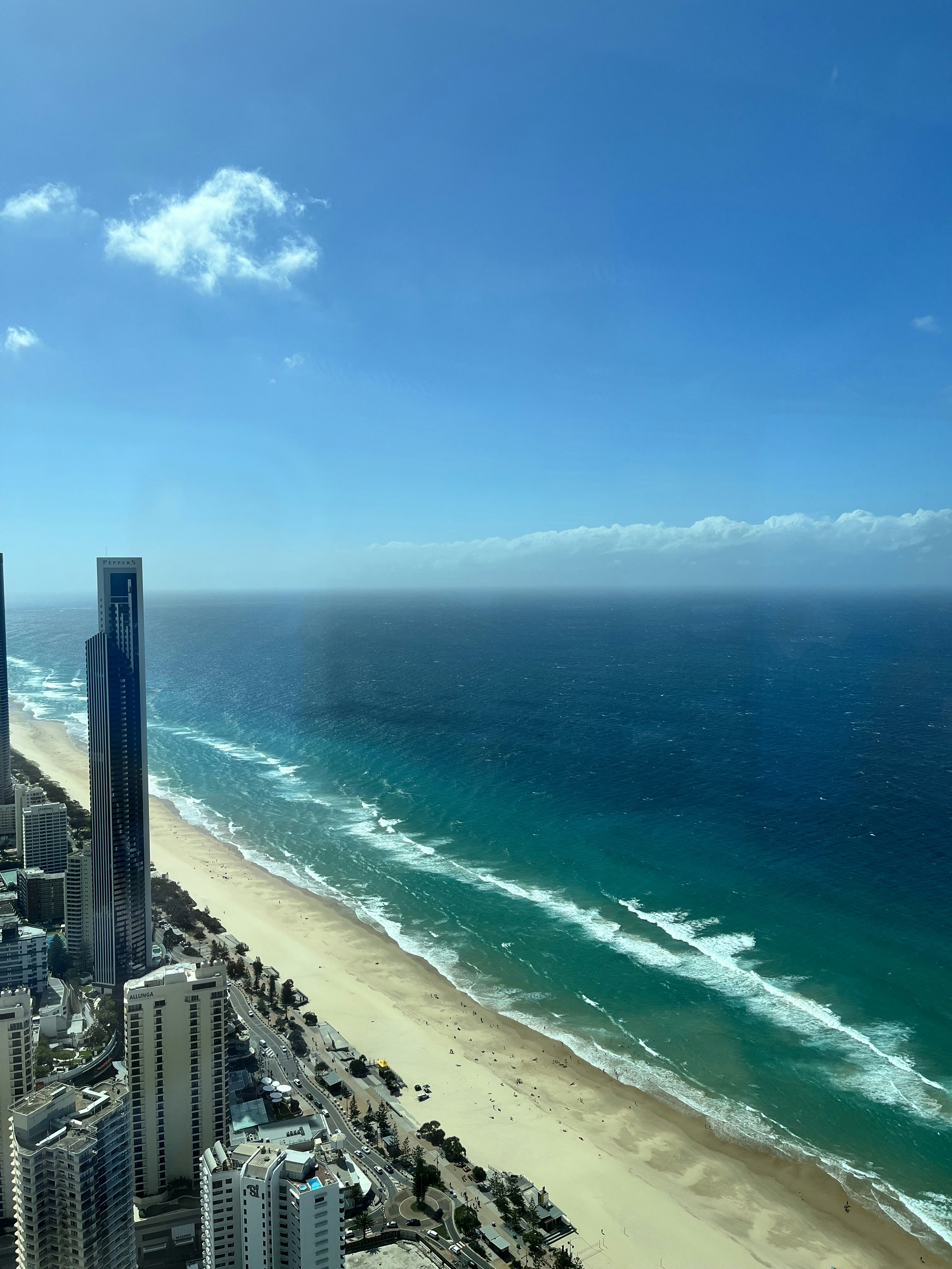 a view of the beach and ocean from a high rise building