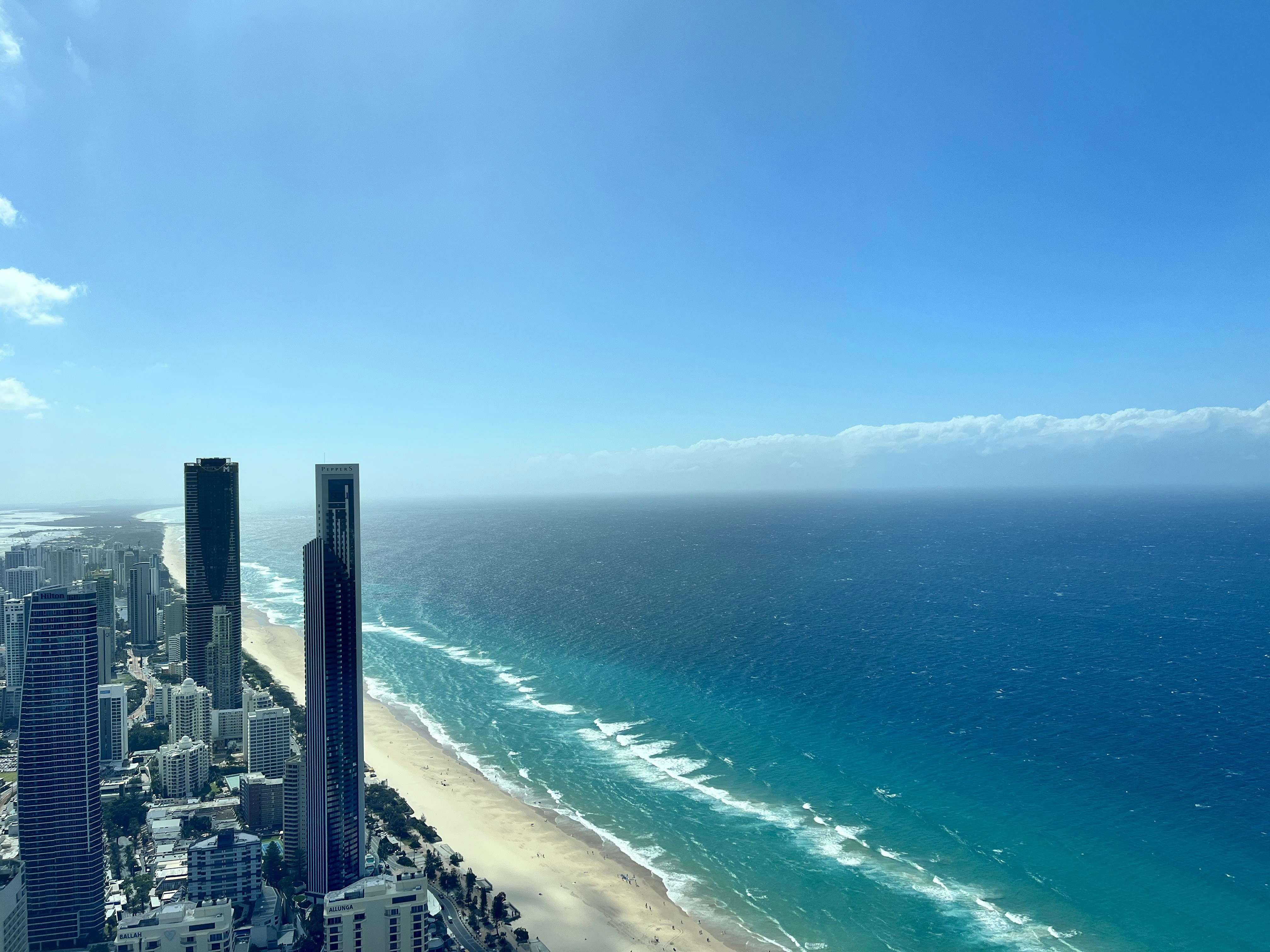 an aerial view of a city and the ocean