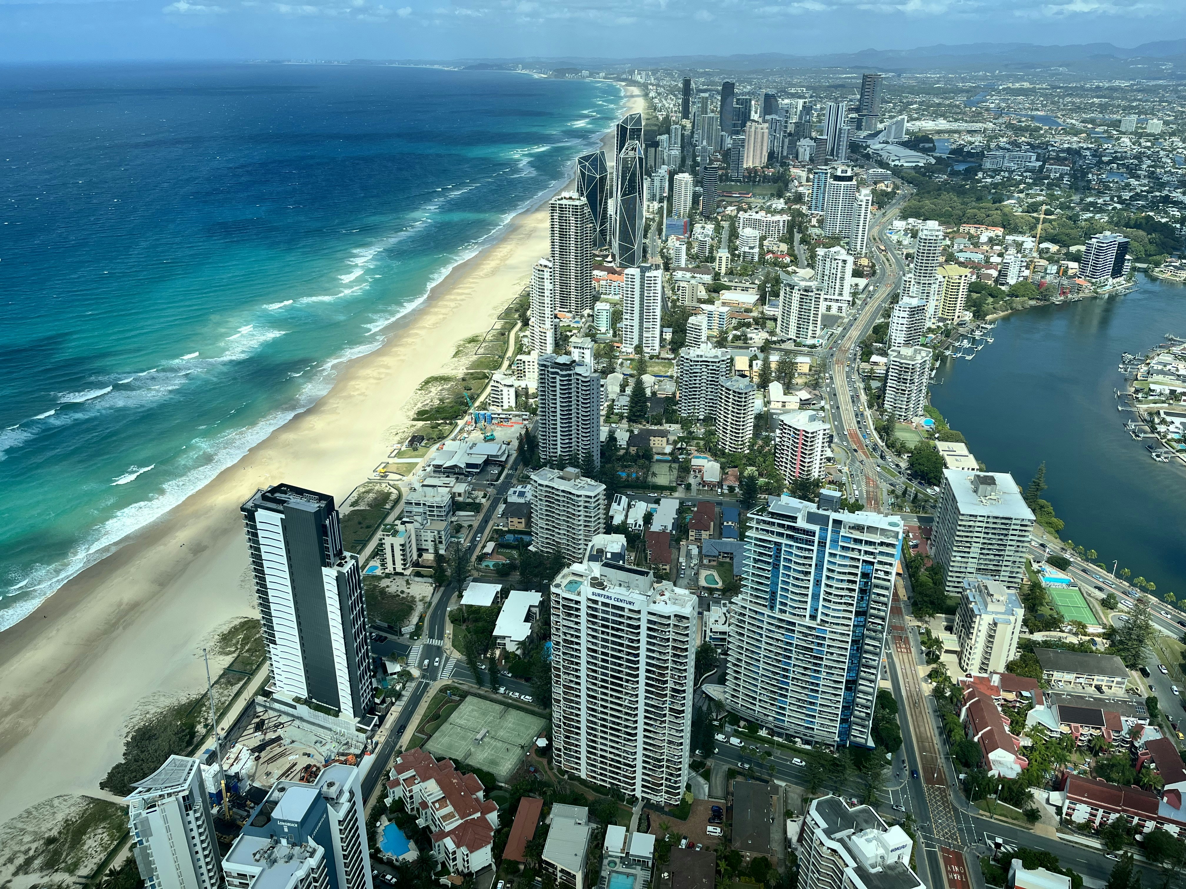 an aerial view of a city and the ocean
