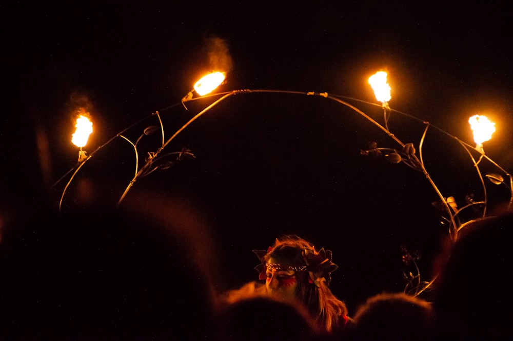 a group of people standing around a circle of torches