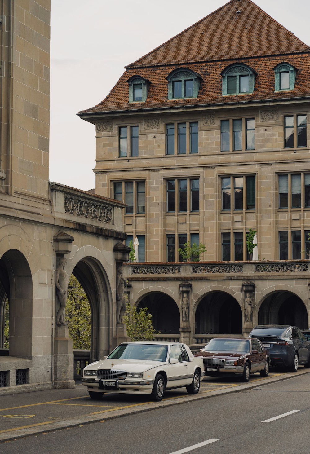 cars parked in front of a large building