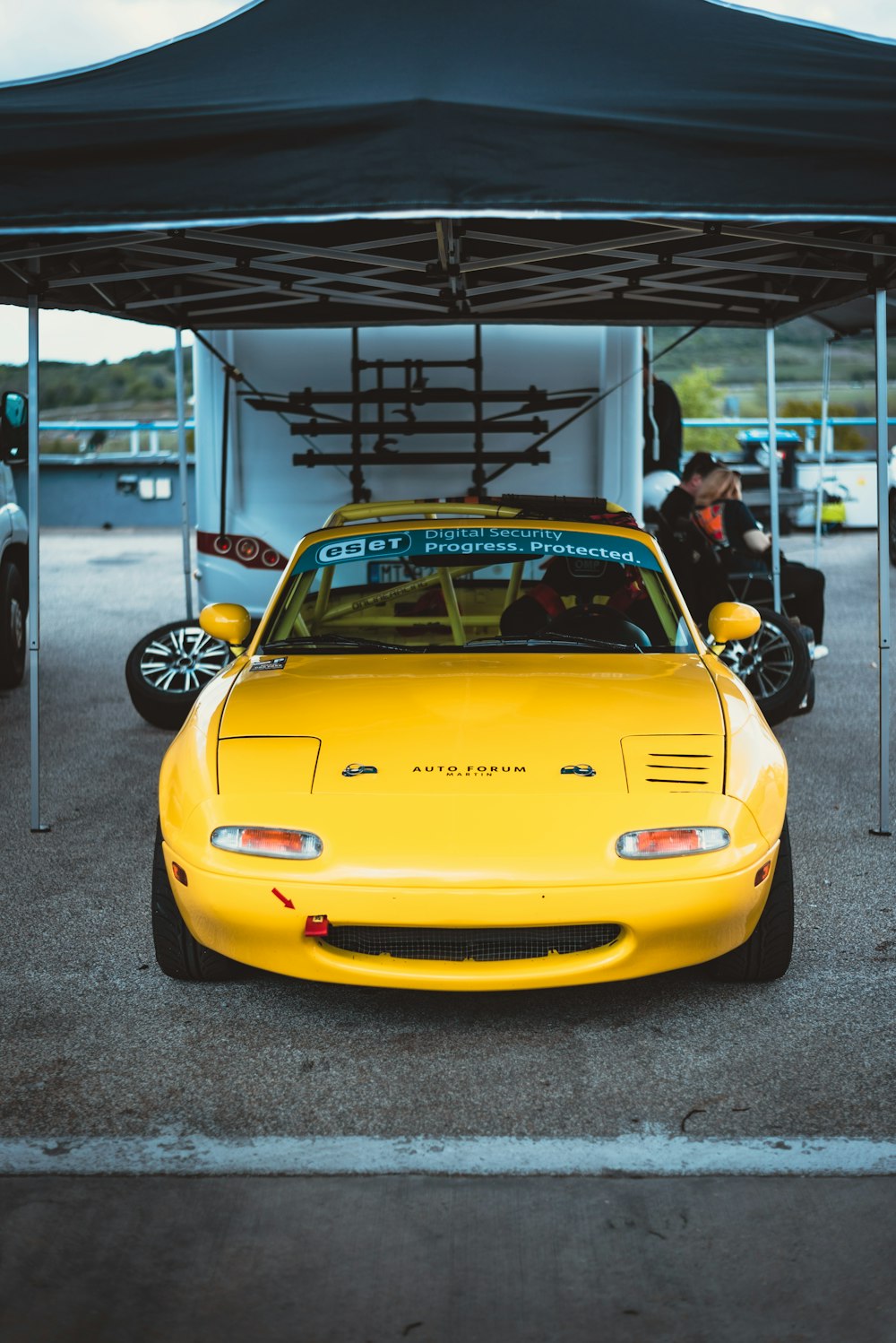 a yellow sports car parked in a parking lot