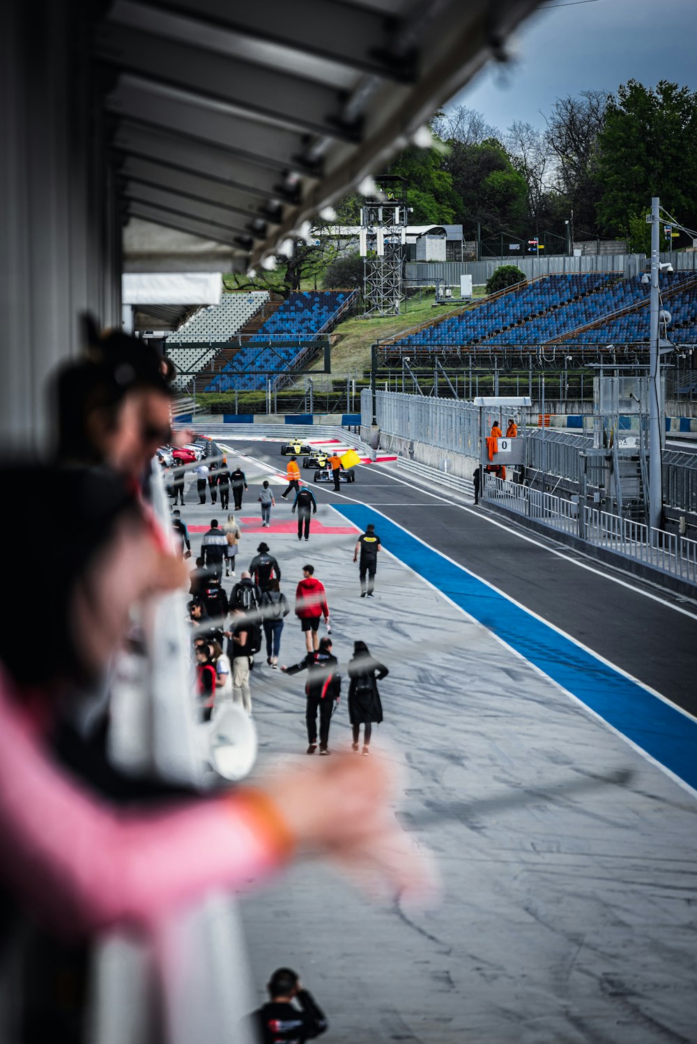 a group of people walking down a race track