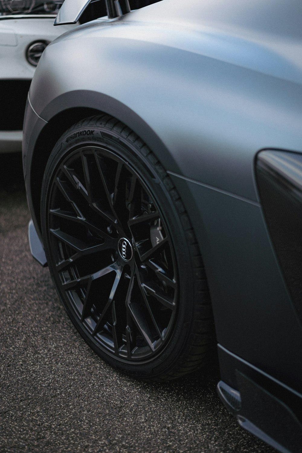 a close up of a sports car parked in a parking lot