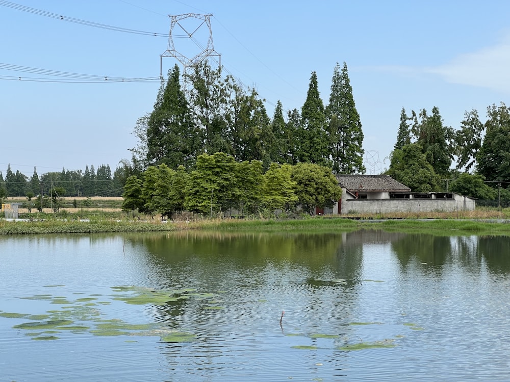 a body of water with a house in the background