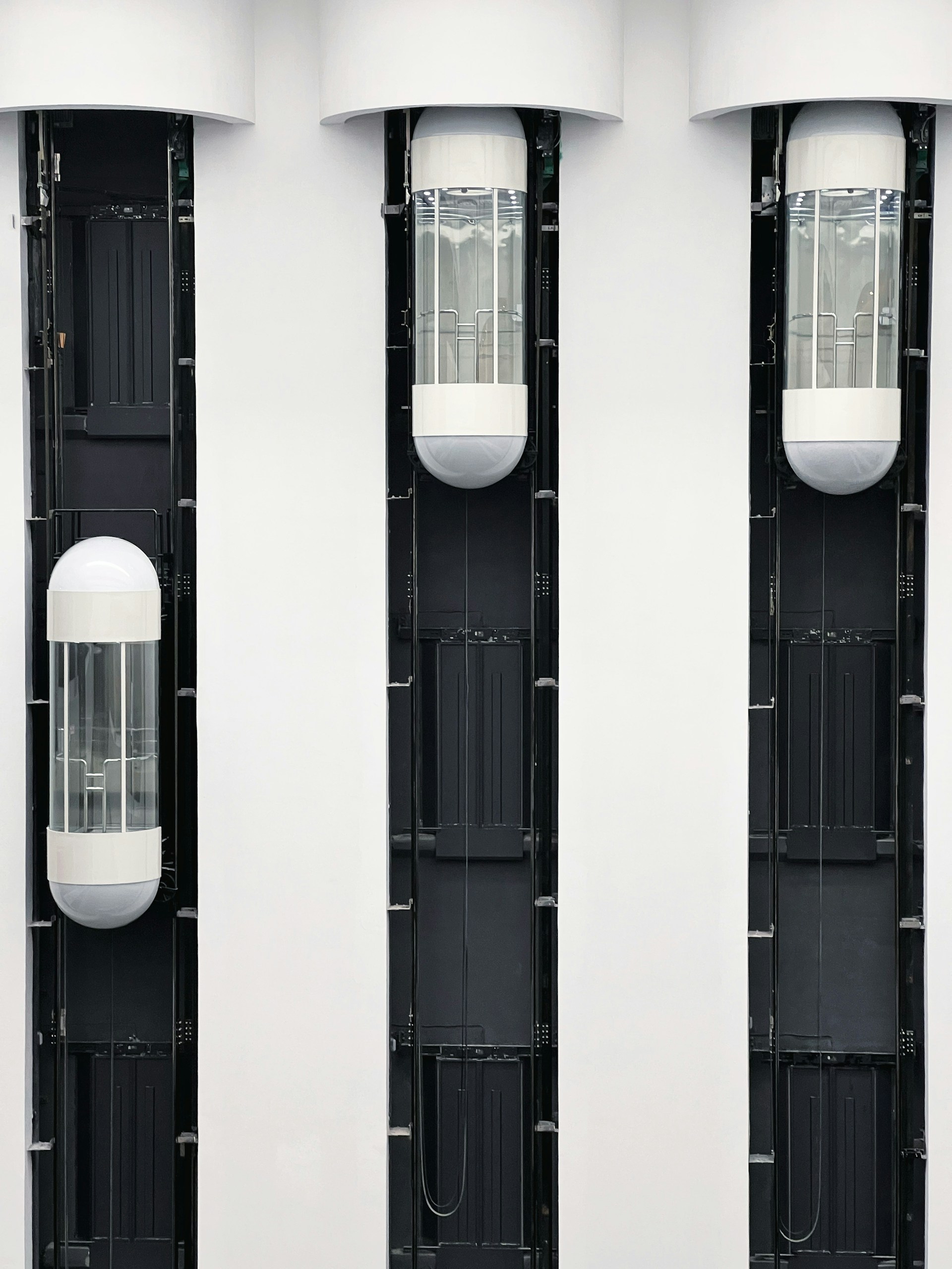 a couple of tall white buildings with windows