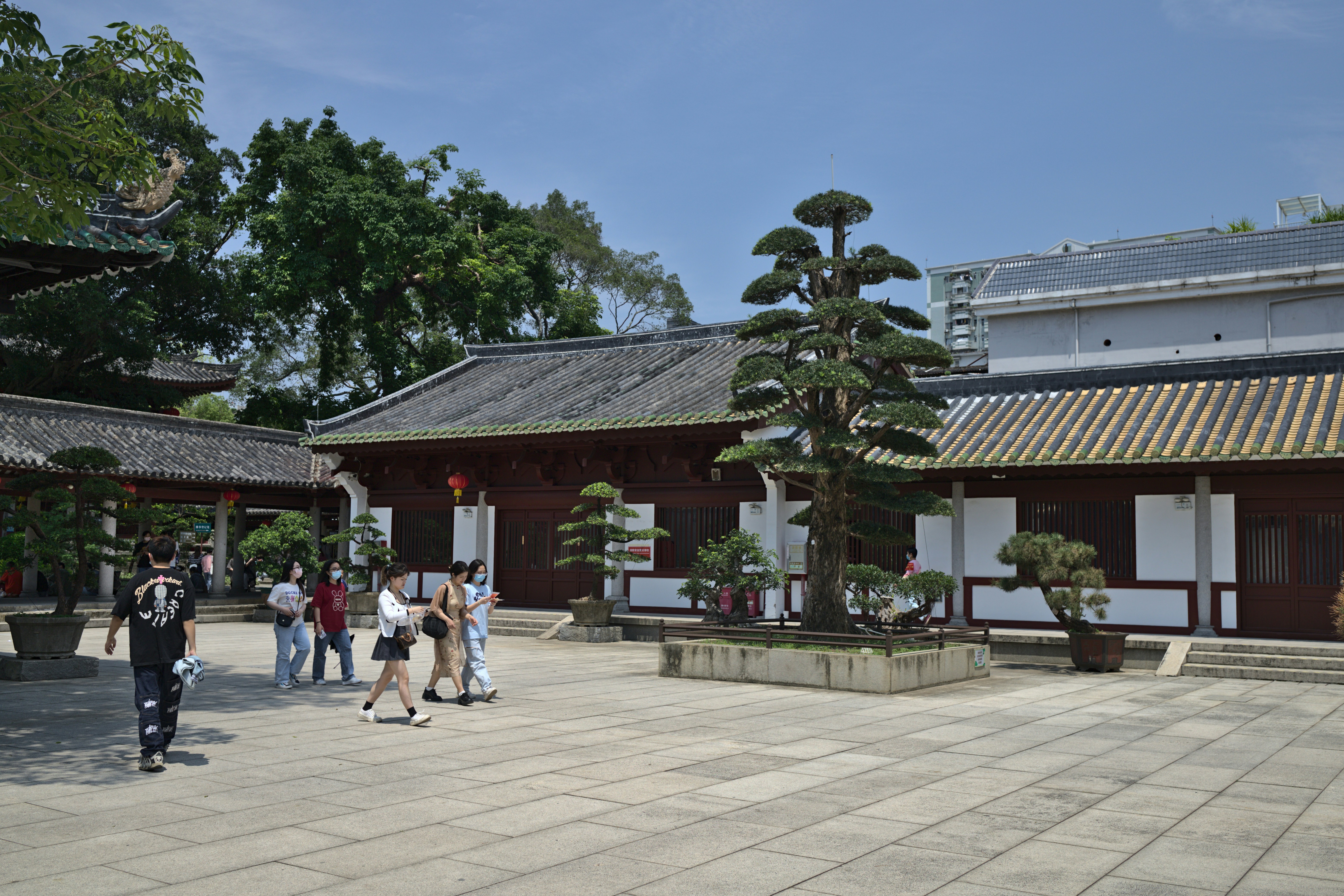 a group of people walking around a courtyard