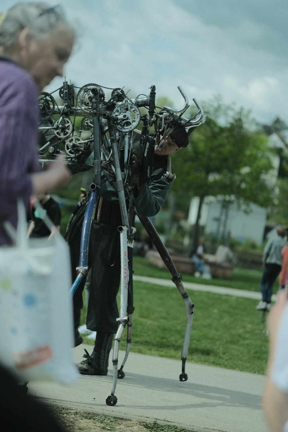 a man standing next to a bunch of bikes on a sidewalk