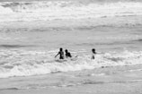 Children playing in the waves at the beach.