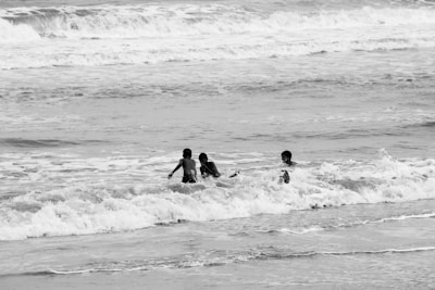 Children playing in the waves at the beach.