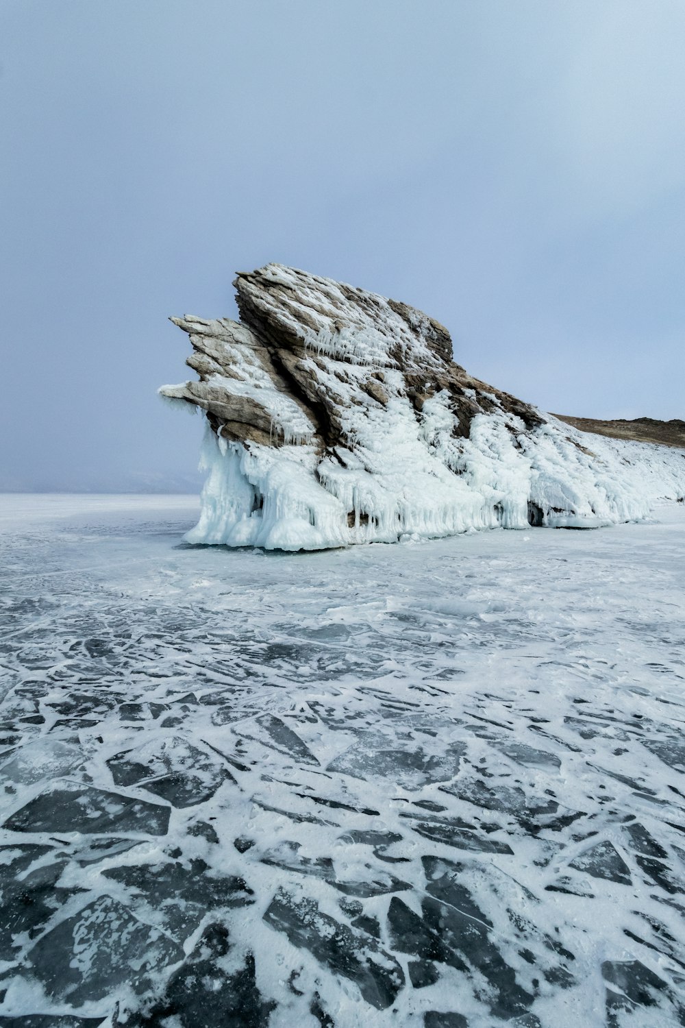 a large iceberg floating on top of a body of water