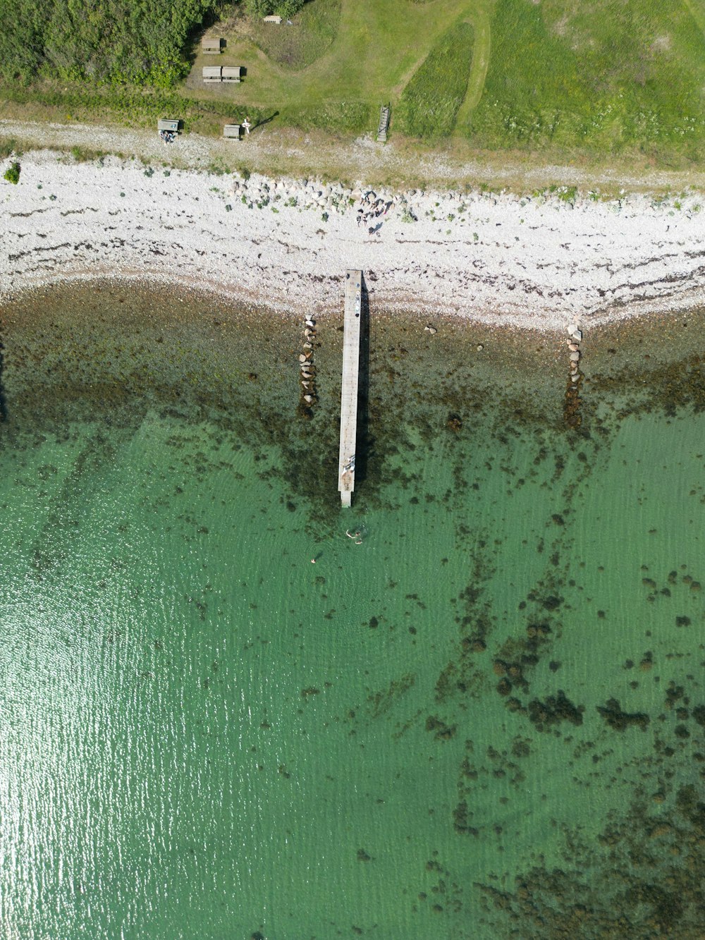 an aerial view of a pier in the water