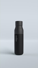 A sleek black bottle standing upright on a light gray background. The bottle has a matte finish and features the word 'aqua' written vertically in a subtle font.