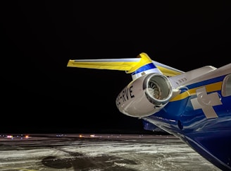 A nighttime exterior shot of an Orvessan jet illuminated by soft runway lights.