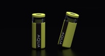 Two yellow cylindrical water bottles with black lids and vertical black stripes featuring the word 'AQUA' are placed against a dark background. One bottle stands upright while the other is slightly tilted.