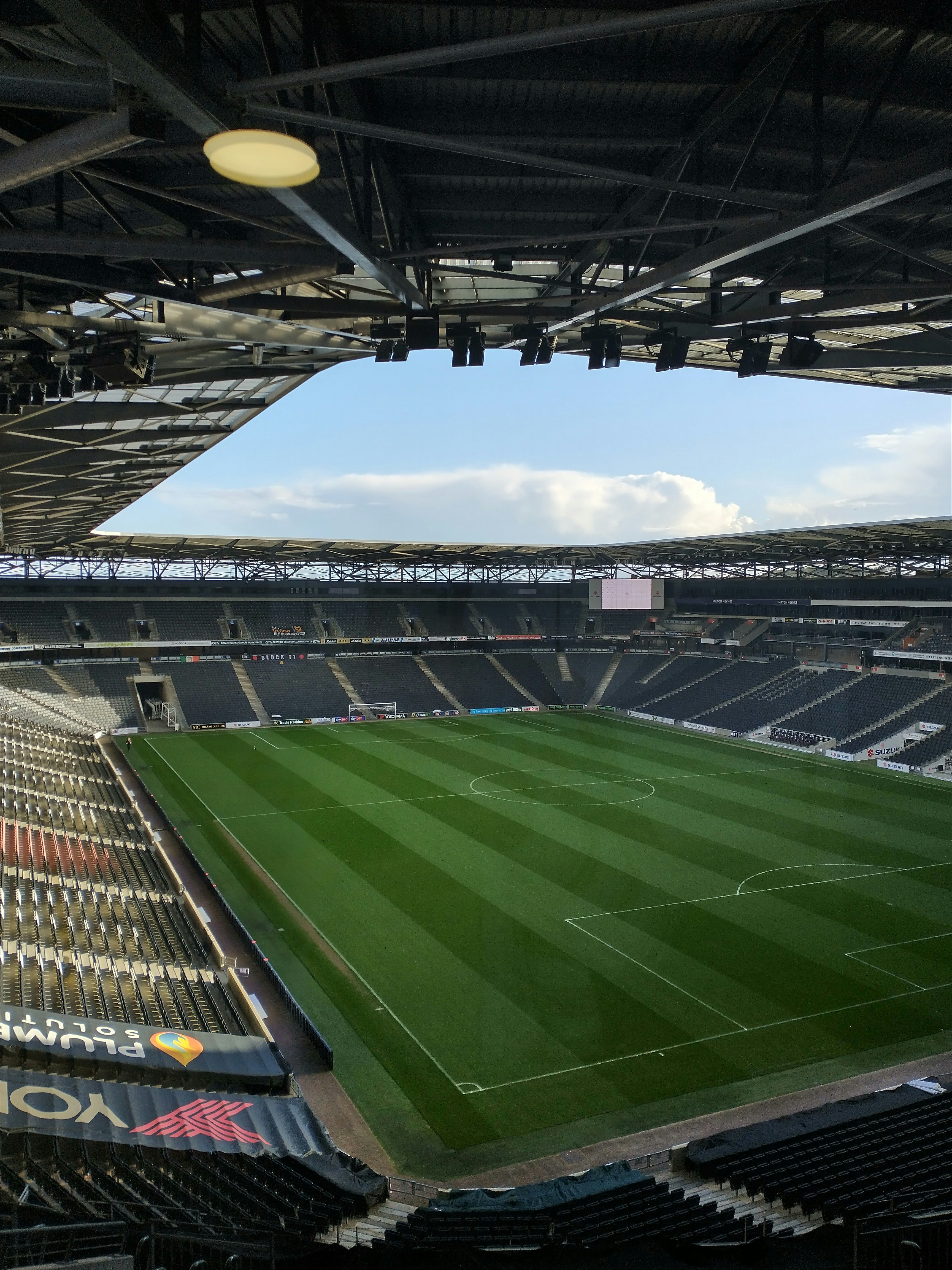 an empty soccer stadium with a green field