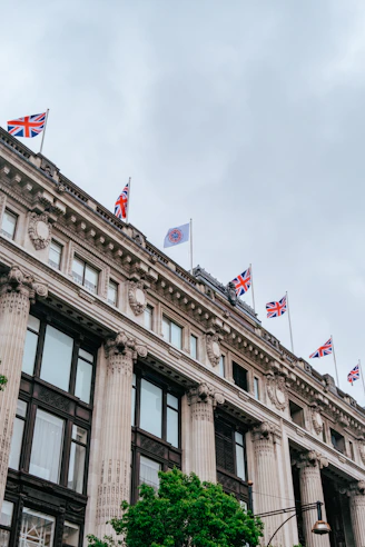 a tall building with flags on top of it