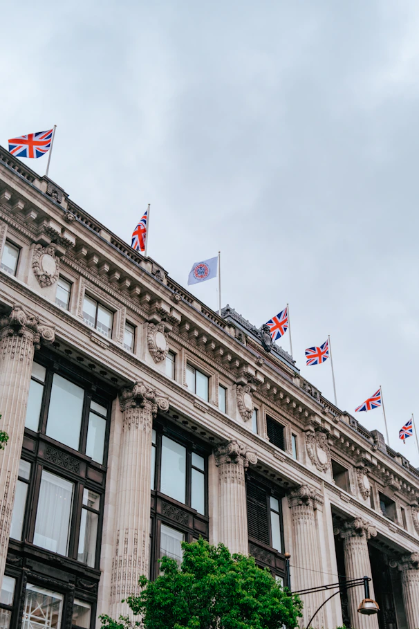 a tall building with flags on top of it