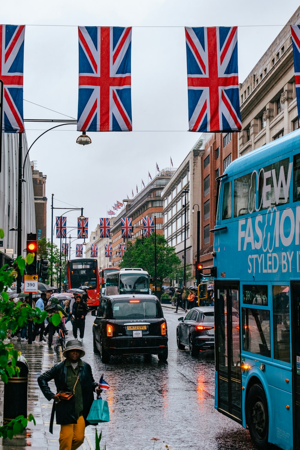 a city street filled with traffic and covered in british flags