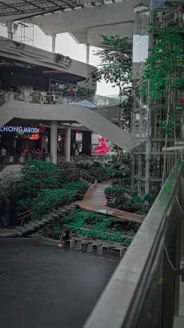 Commercial shopping mall area enhanced by vibrant, maintenance-free greenery installations.