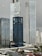 Several high-rise buildings are in an urban area with overcast skies. Prominent skyscrapers feature glass facades and modern architecture, including a building with a visible 'Westin' logo. The foreground shows a rooftop landscape with residential structures and greenery.