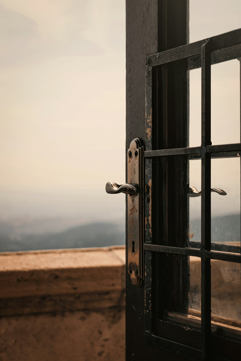 an open door with a view of a mountain