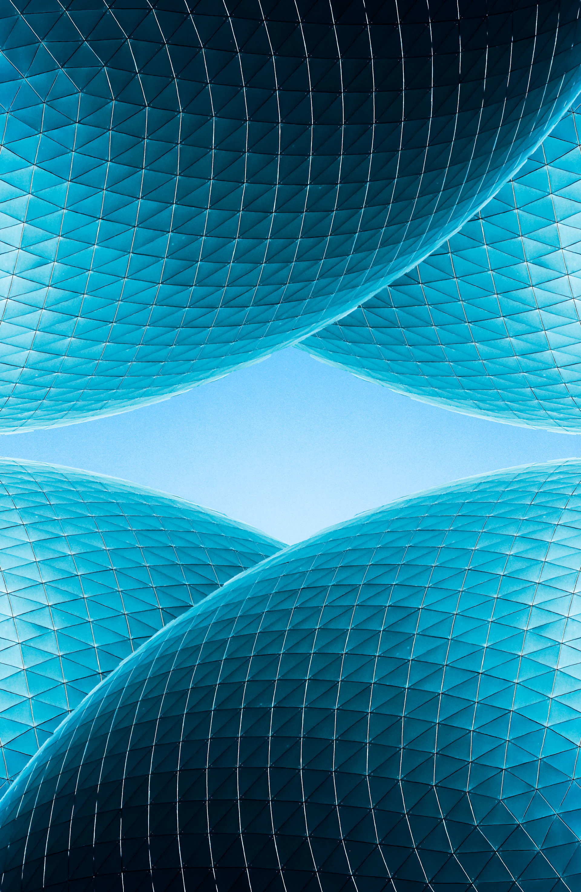 an abstract photo of a blue building with a blue sky in the background
