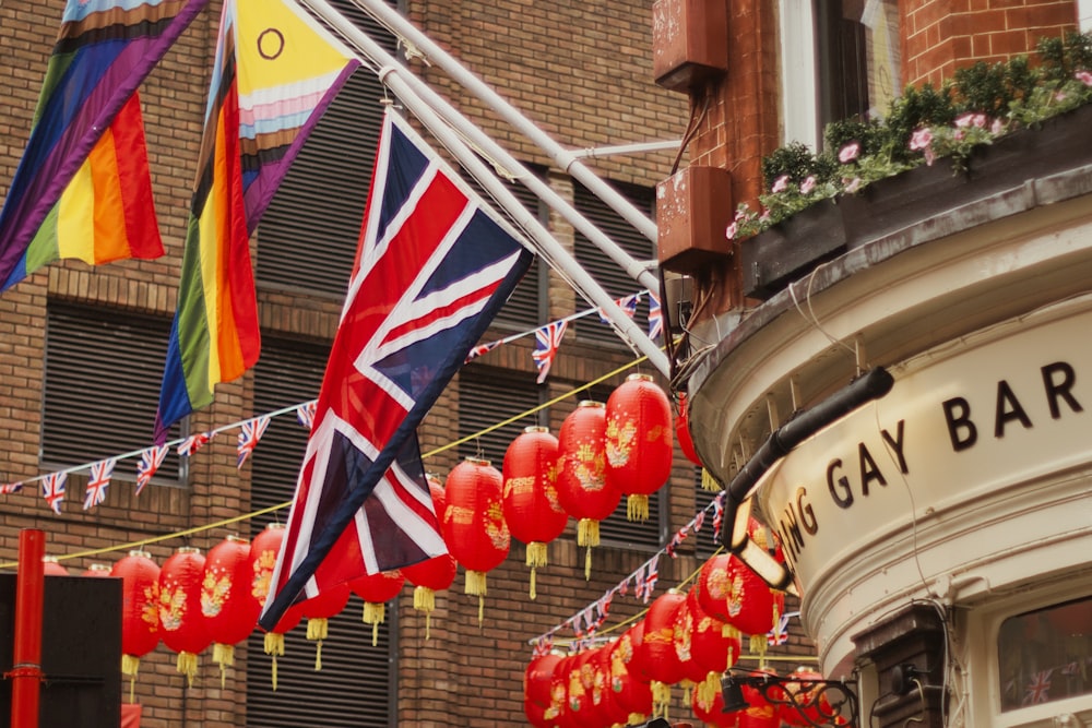 a bunch of flags hanging from a building