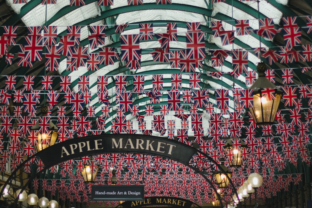 the interior of an apple market with flags hanging from the ceiling