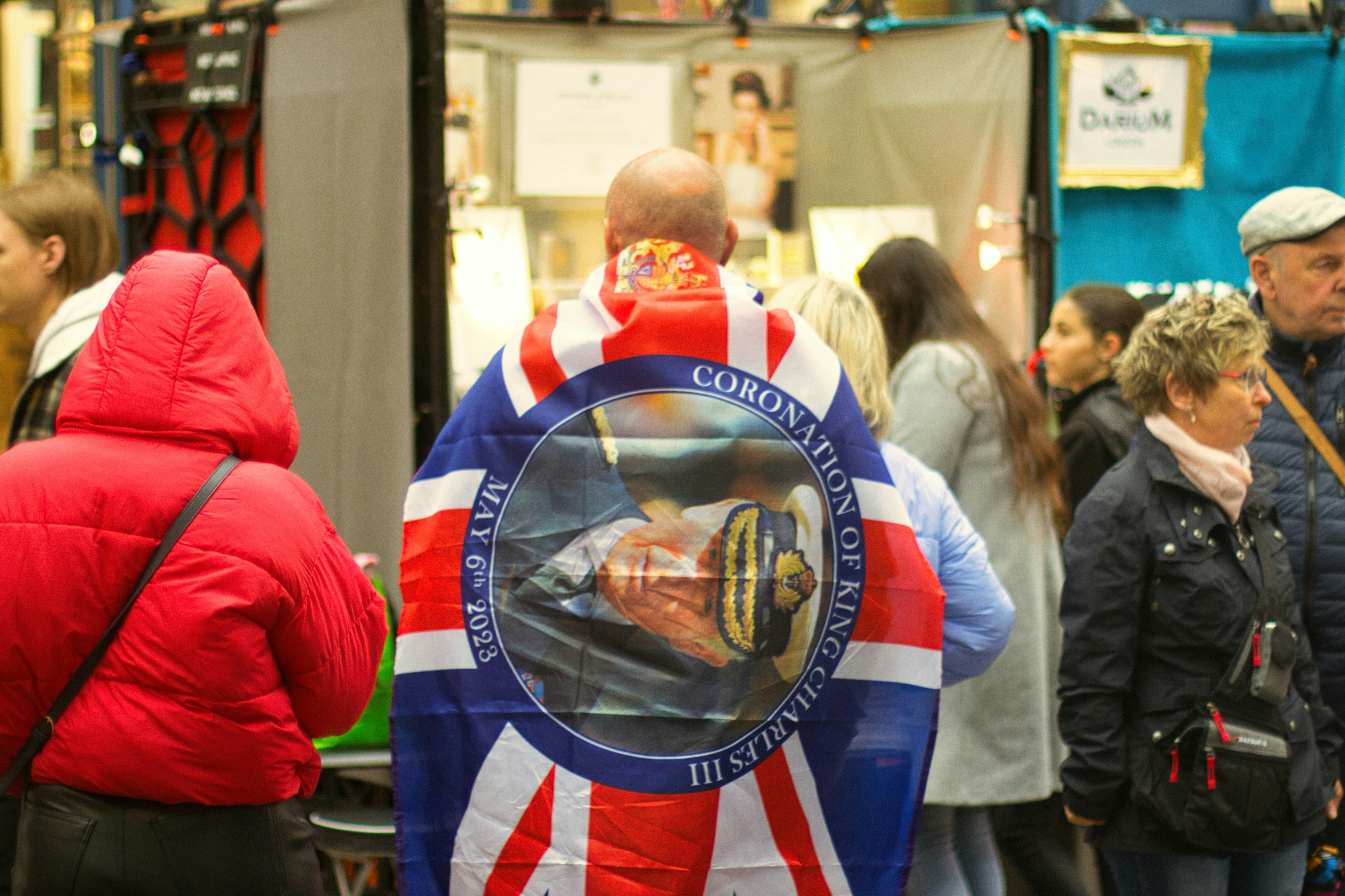 a group of people standing around a booth